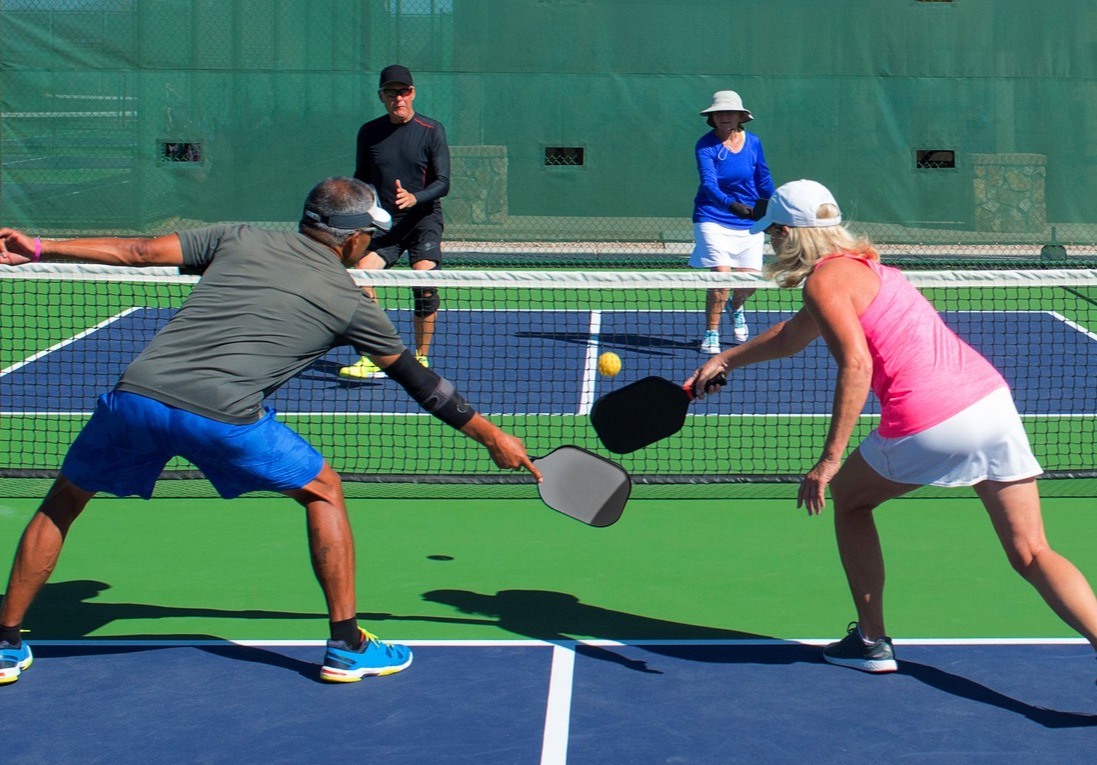 pair of people playing pickleball