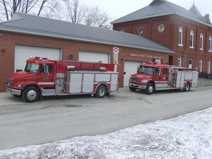 Fire station in Embro, 2 fire trucks outside the garage doors of the building