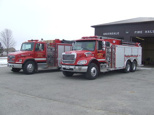 2 fire trucks outside of the Uniondale fire hall