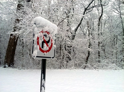 parking sign covered in snow